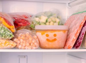 Frozen food in the freezer. Frozen vegetables, soup, ready meals in the freezer